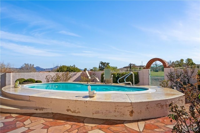 view of pool featuring a patio, fence, and a fenced in pool