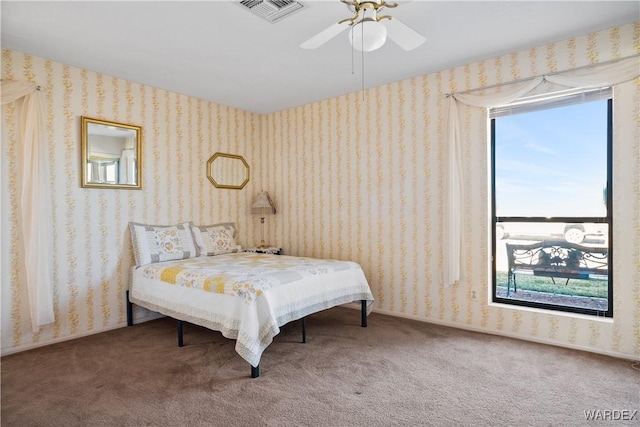 bedroom with wallpapered walls, carpet, and visible vents