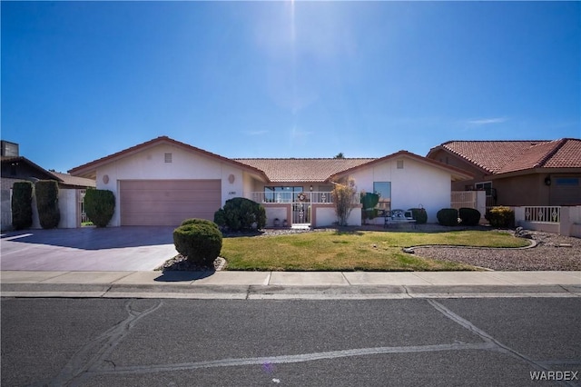 ranch-style house featuring an attached garage, a front lawn, concrete driveway, and stucco siding