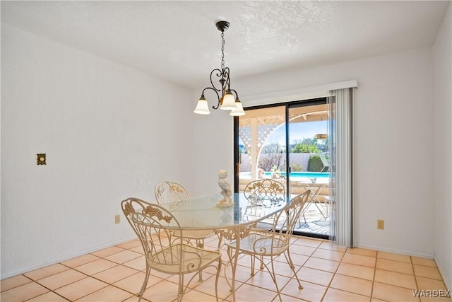 dining room featuring tile patterned flooring, a textured ceiling, baseboards, and an inviting chandelier