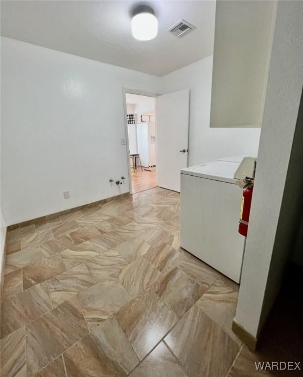 washroom with laundry area, visible vents, and washer / clothes dryer