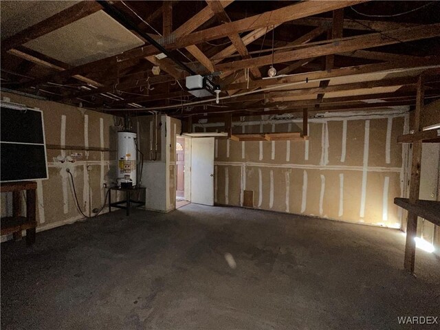 garage with a garage door opener and water heater