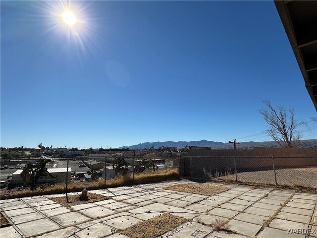 view of patio / terrace featuring a mountain view and fence