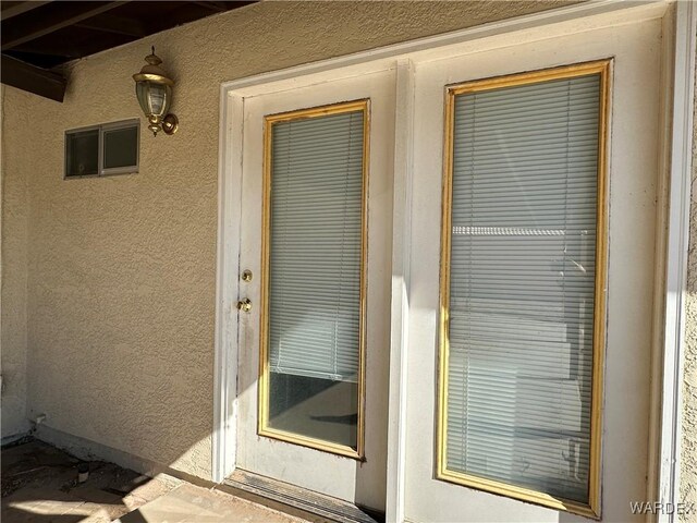 property entrance with stucco siding