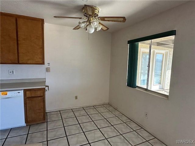 unfurnished dining area with light tile patterned floors and ceiling fan