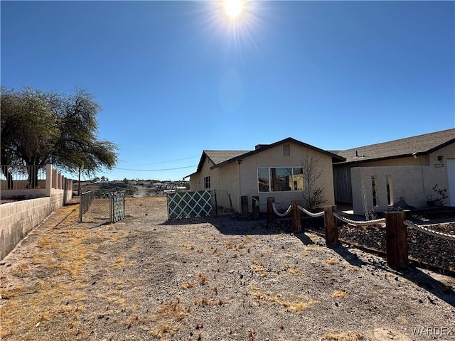 view of property exterior with fence and stucco siding