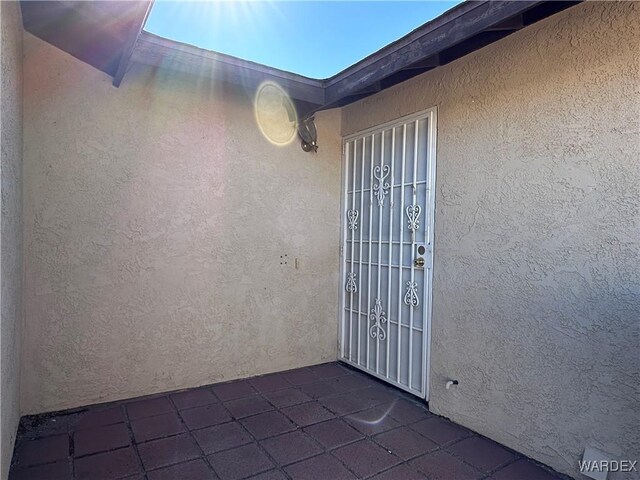 property entrance featuring stucco siding