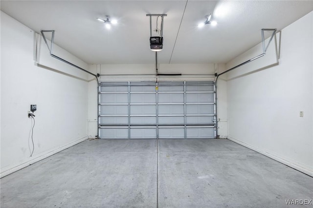 garage with a garage door opener and baseboards