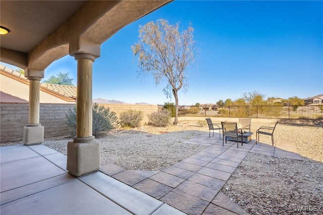 view of patio with a fire pit and a fenced backyard