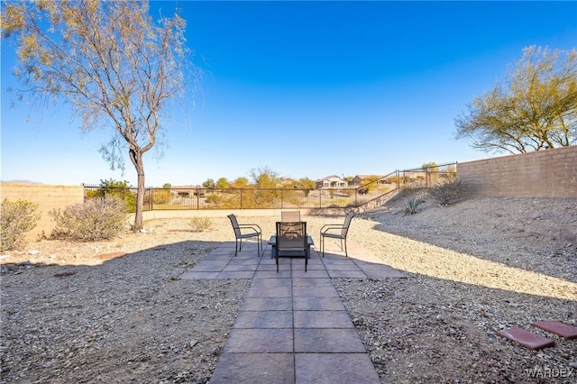 view of patio featuring a fire pit and a fenced backyard