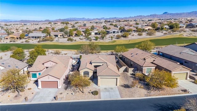 drone / aerial view with a residential view, a mountain view, and golf course view