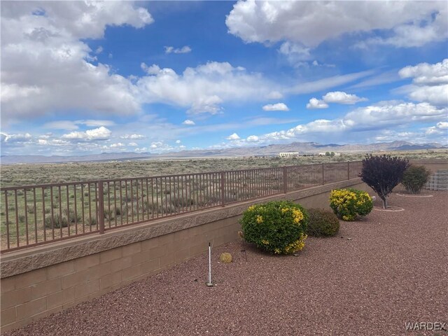 view of yard with fence and a mountain view