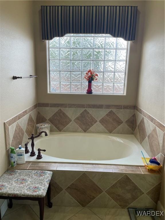 bathroom with a garden tub