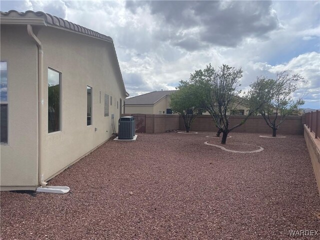 view of yard featuring central air condition unit and a fenced backyard