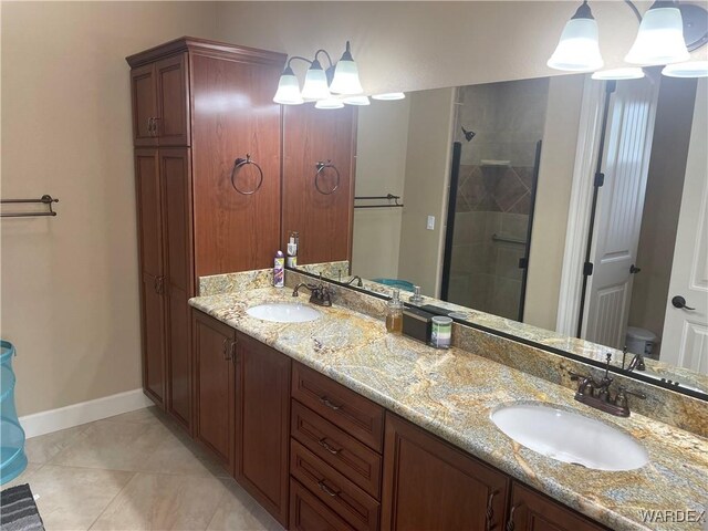 bathroom with toilet, a shower stall, double vanity, and a sink