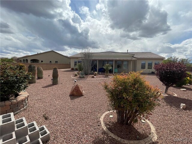 back of house with fence and stucco siding