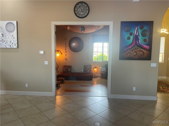 interior space with tile patterned flooring and baseboards