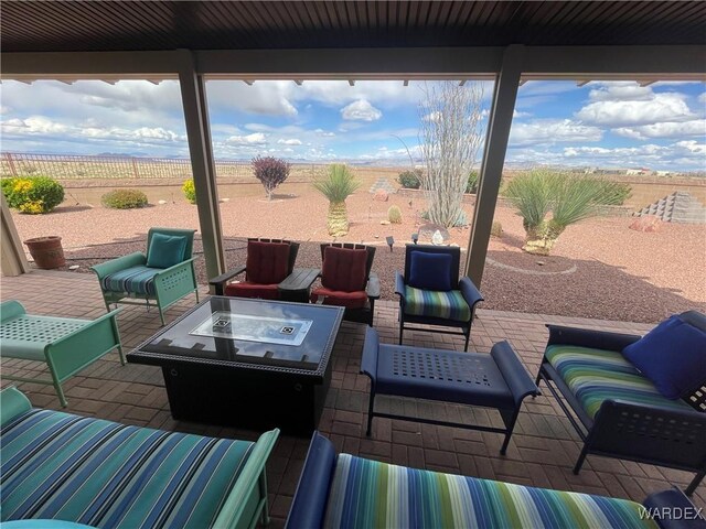 view of patio / terrace featuring a fenced backyard and an outdoor living space with a fire pit