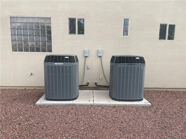 details with stucco siding and central AC unit