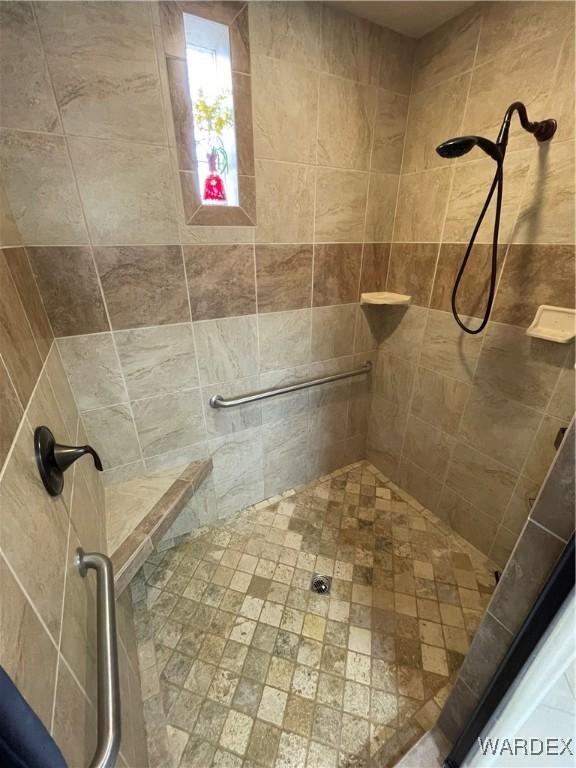 bathroom with a tile shower