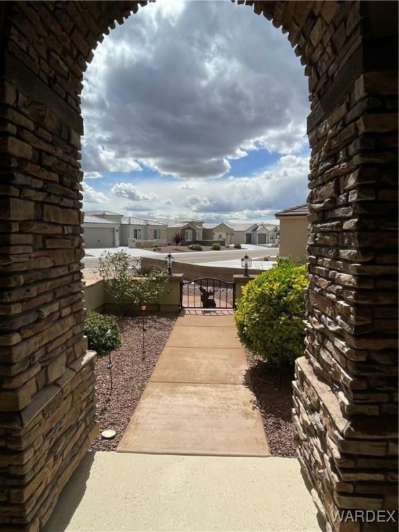 view of patio with a residential view, a gate, and fence