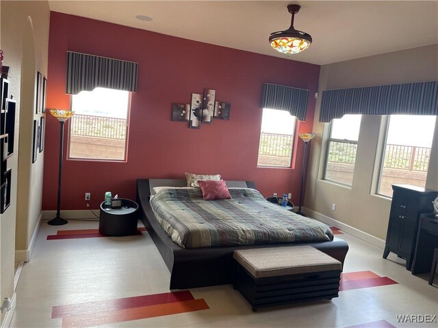 bedroom with light wood-type flooring and baseboards