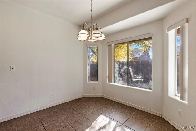 unfurnished dining area featuring baseboards, tile patterned floors, and a notable chandelier