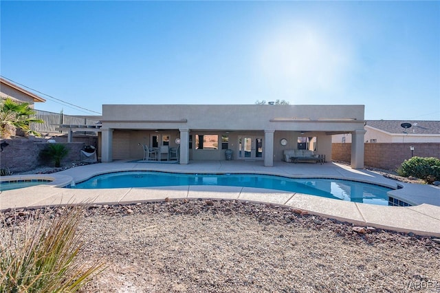 view of swimming pool featuring a fenced in pool, a patio, fence, and an in ground hot tub