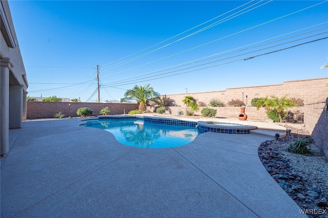 view of pool with a patio area, a fenced backyard, and a pool with connected hot tub