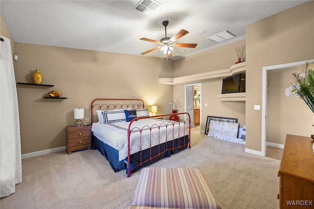 bedroom featuring baseboards, visible vents, and light colored carpet