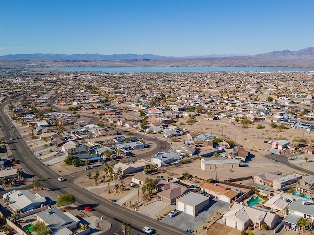 drone / aerial view featuring a residential view and a water and mountain view