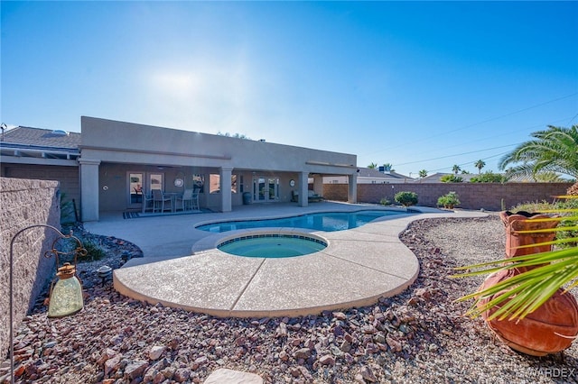 view of swimming pool with a fenced backyard, a patio, and an in ground hot tub