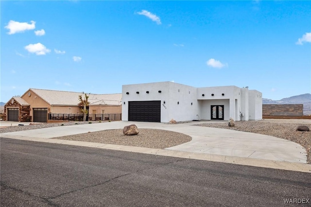 adobe home with stucco siding and driveway