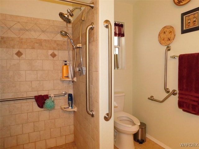 full bath with baseboards, a tile shower, and toilet