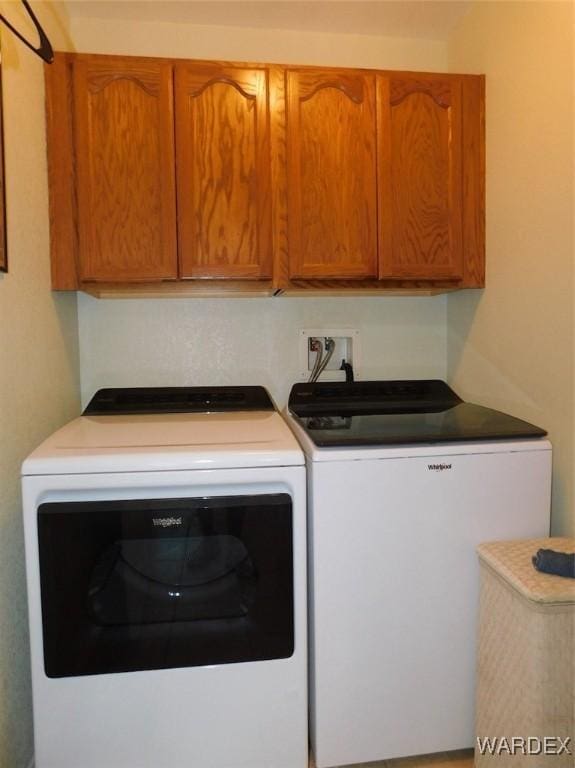 washroom with cabinet space and independent washer and dryer