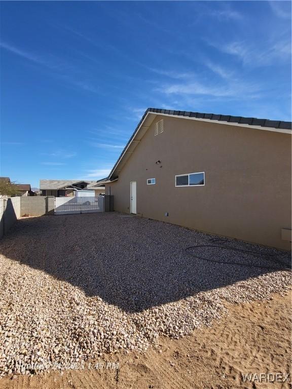 view of home's exterior featuring fence and stucco siding