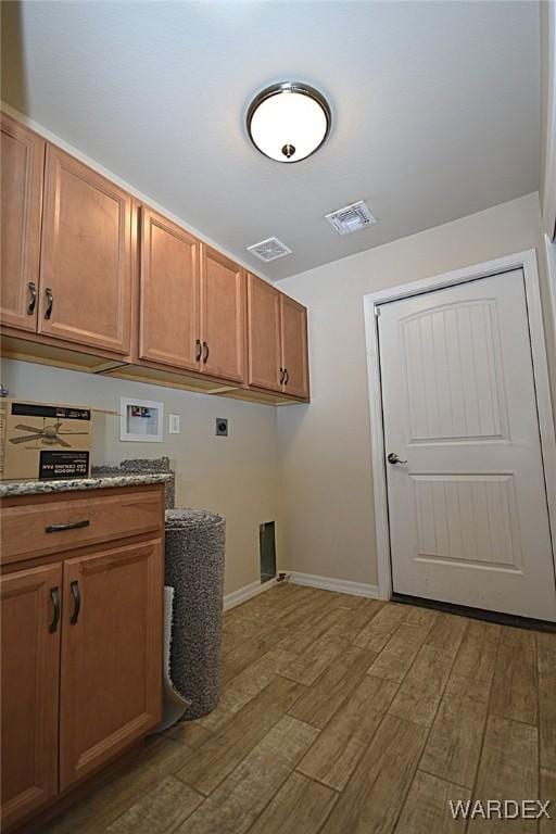 washroom with washer hookup, cabinet space, visible vents, dark wood-type flooring, and hookup for an electric dryer