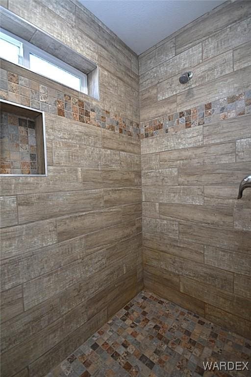 bathroom featuring tiled shower