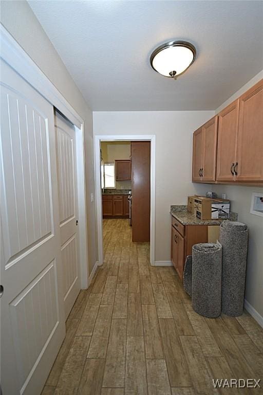 kitchen with light wood finished floors and brown cabinetry