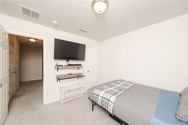 carpeted bedroom with visible vents and baseboards