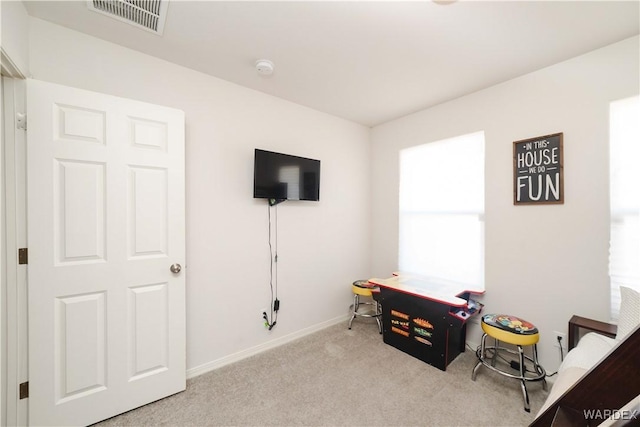 office space featuring carpet, visible vents, and baseboards