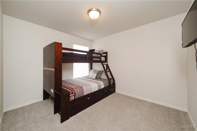 unfurnished bedroom featuring carpet flooring and baseboards