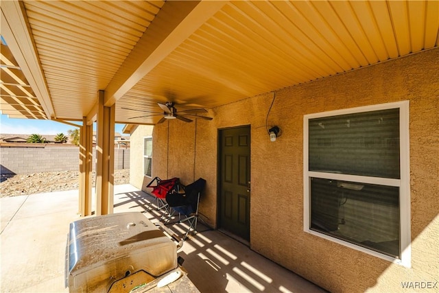 view of patio featuring ceiling fan and fence