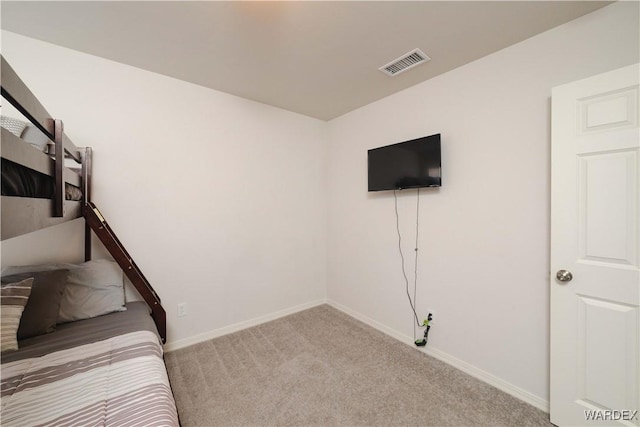 unfurnished bedroom with carpet floors, baseboards, and visible vents