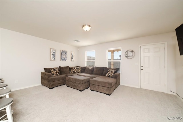 carpeted living room with baseboards