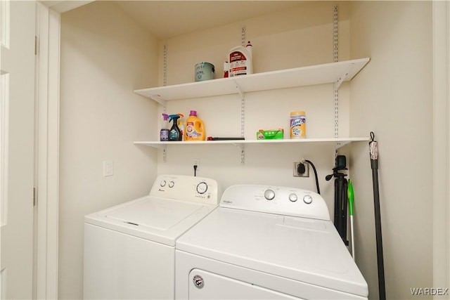 clothes washing area with washer and dryer and laundry area