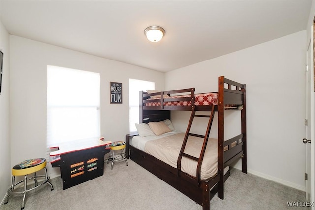 carpeted bedroom with baseboards