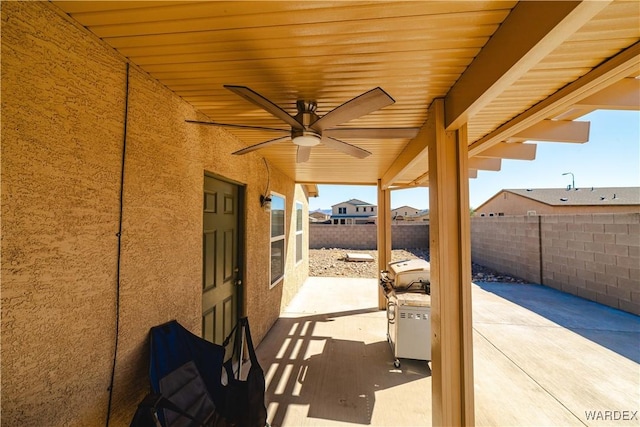 view of patio featuring fence private yard and a ceiling fan