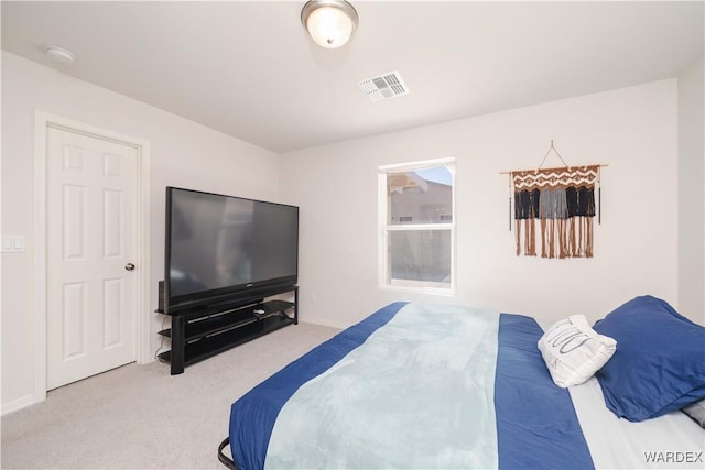 carpeted bedroom with baseboards and visible vents