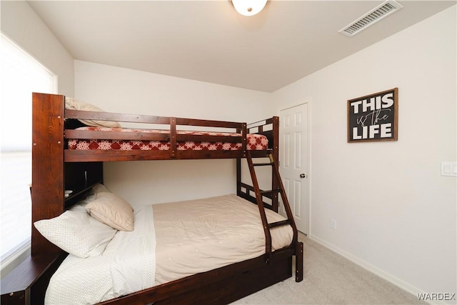 carpeted bedroom with visible vents and baseboards